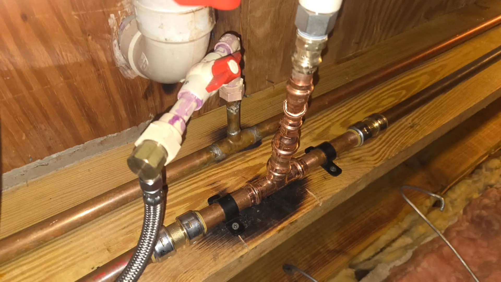 New copper water supply lines and shutoff valves under a floor