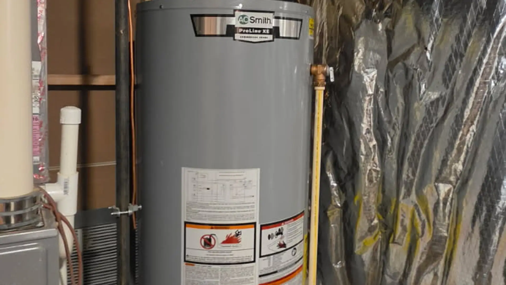 New power vent gas water heater installed in a utility closet