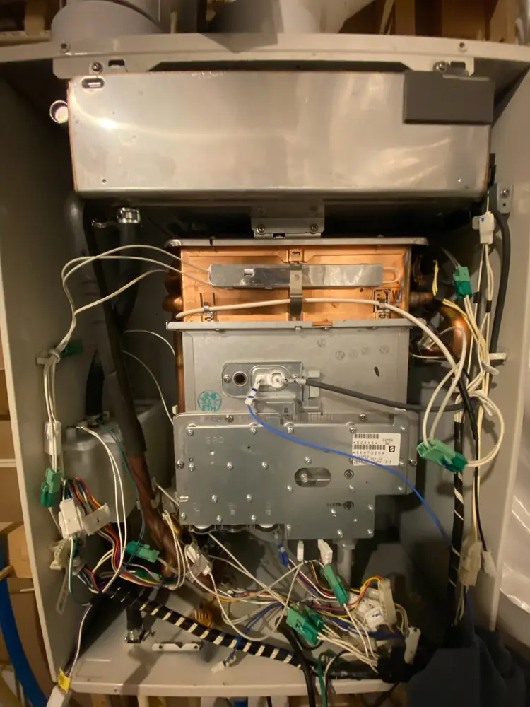 Noritz tankless water heater with the front cover removed for diagnosis