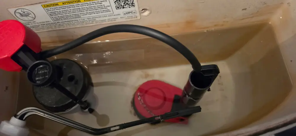 Toilet tank with new flapper and fill valve