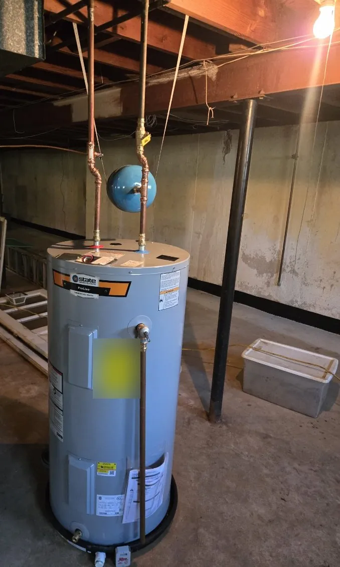 New gray State ProLine electric water heater in a black drip pan with a blue expansion tank above it in an unfinished basement