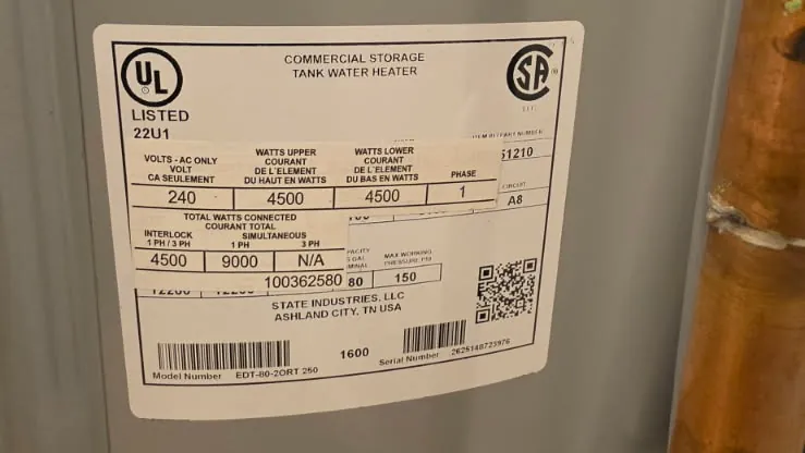 Nameplate on the new commercial storage tank water heater showing 240 volts and 4500-watt elements
